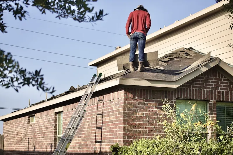 Professional roofer working on a residential roof in The Woods of Bartlett